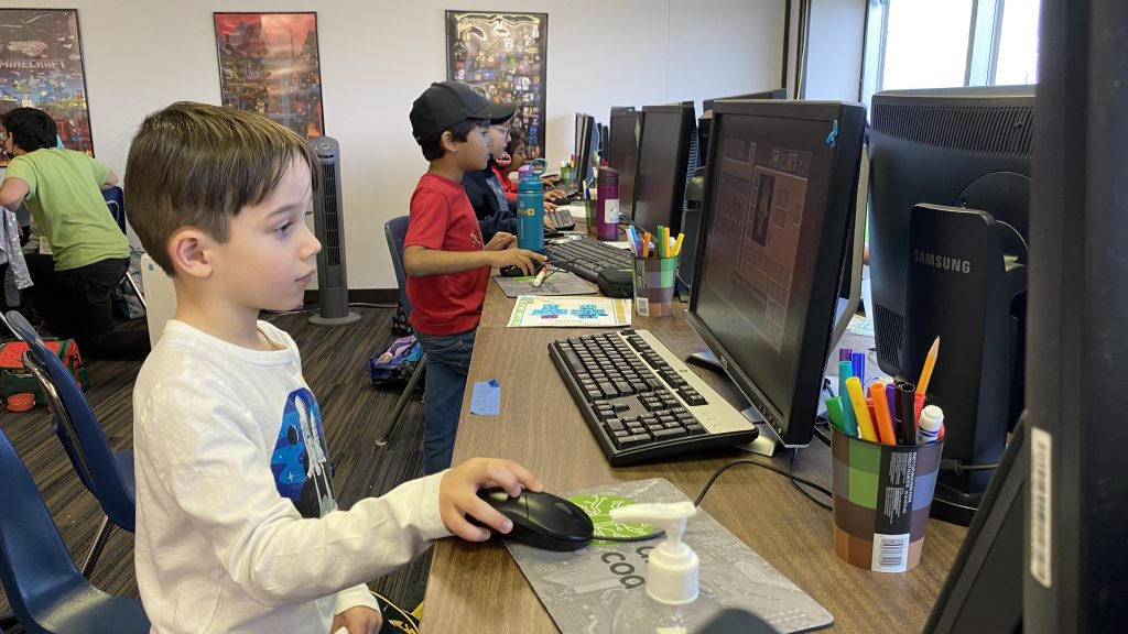 Student plays Minecraft on Computer at a coding summer camp at Discover Coding West Edmonton