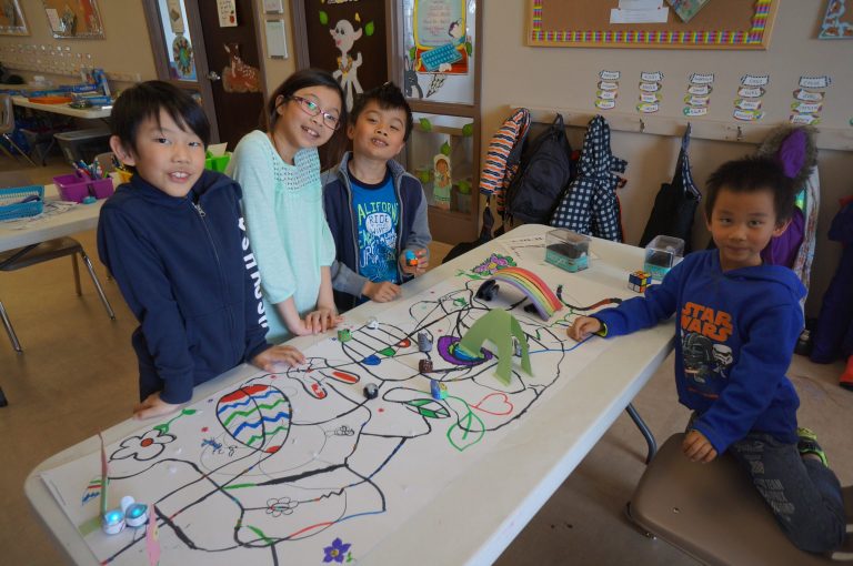 Students playing with robots in a summer coding camp in Edmonton