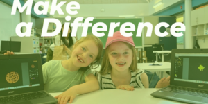 Two Discover Coding students smiling with their laptops.